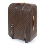 LOUIS VUITTON SUITCASE a large suitcase with monogrammed exterior and leather handles and strap,