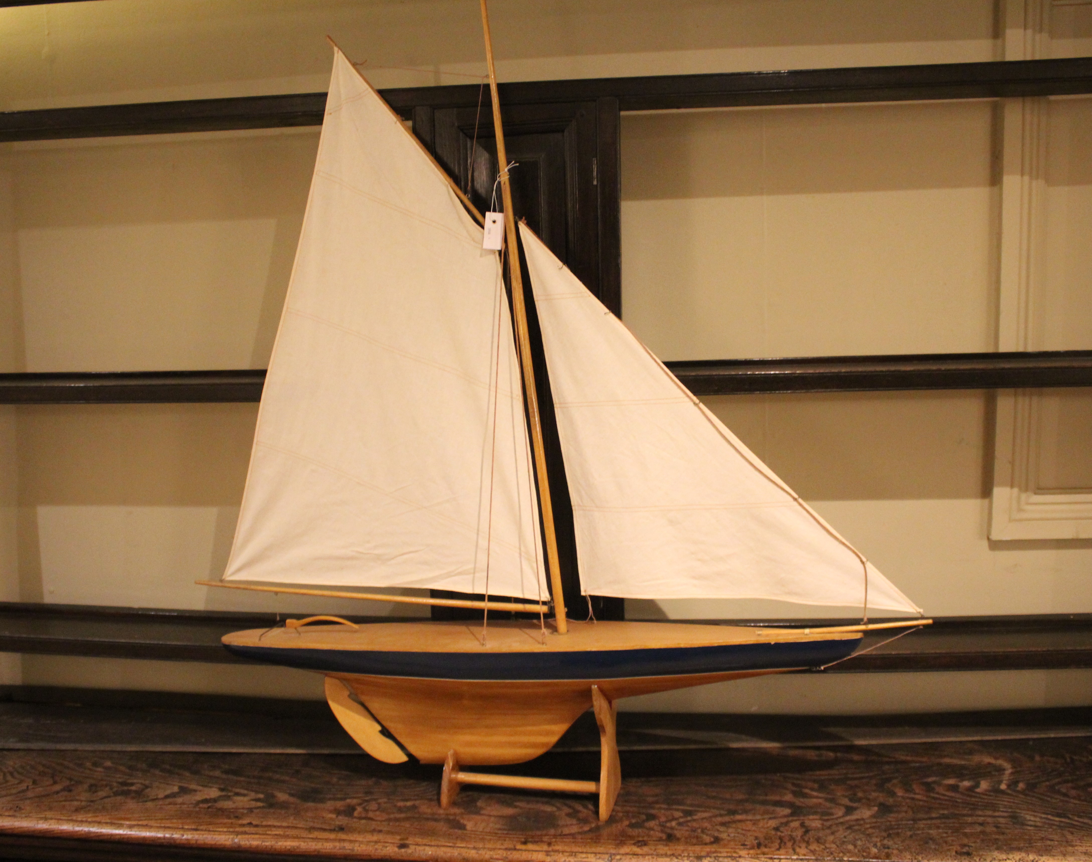 MODEL POND YACHT a wooden model Pond Yacht complete with sails and rigging, and with a wooden stand.