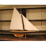 MODEL POND YACHT a wooden model Pond Yacht complete with sails and rigging, and with a wooden stand.