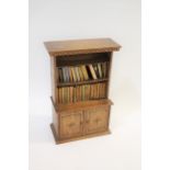 MINIATURE BOOKCASE & BOOKS a miniature oak bookcase with 2 shelves in the top section and