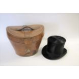 LEATHER CASED TOP HAT a leather case with a red silk lined interior, with a carrying handle and