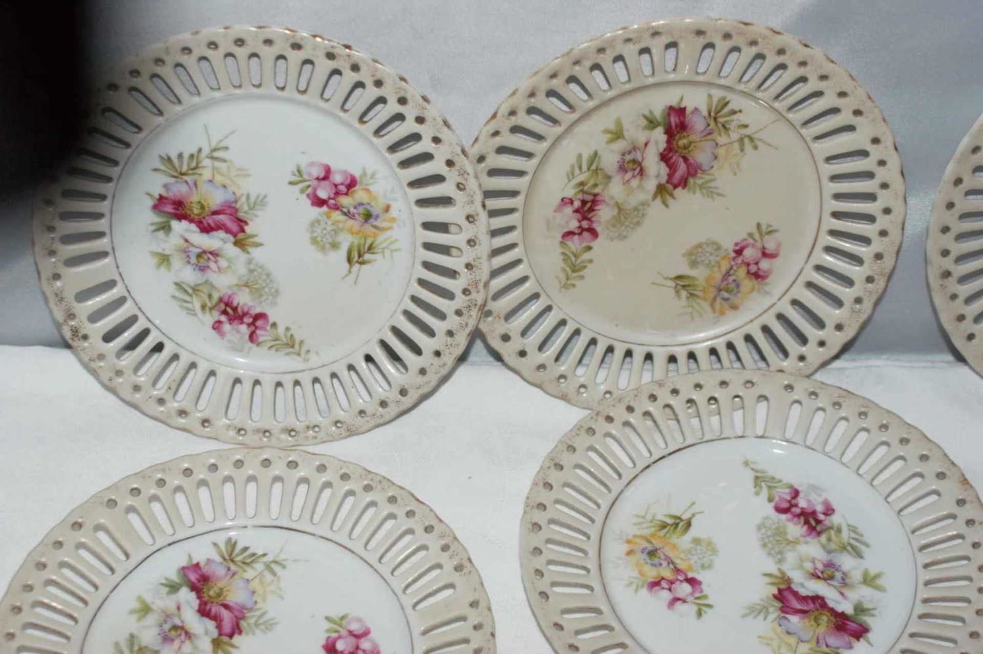 Porcelain, 12 breakthrough plates around 1920 with floral repurposed decoration. - Image 2 of 2
