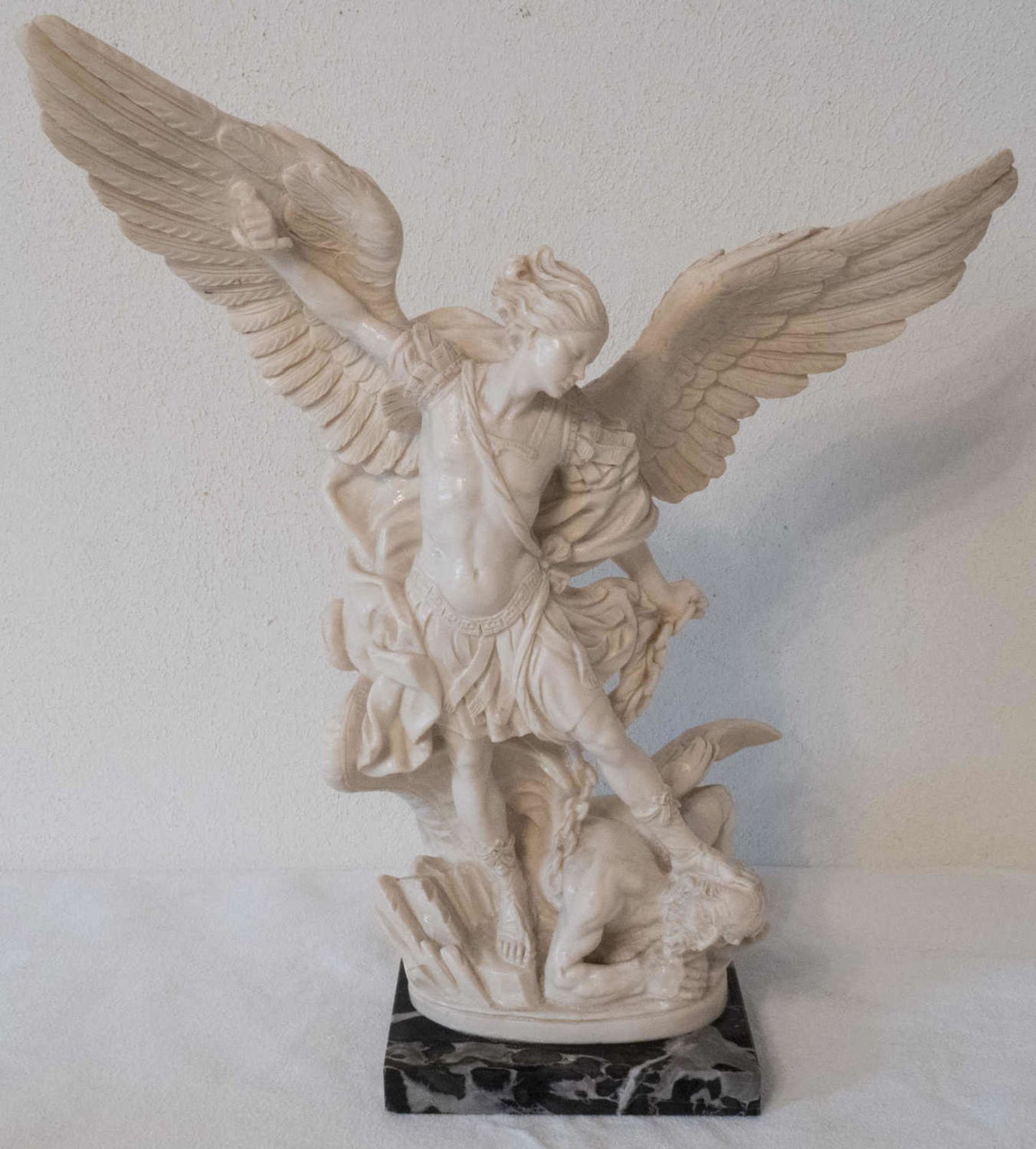 Sacral figure, Archangel Michael over fallen angel "hell fall". On marble base. Height: about 40 cm.