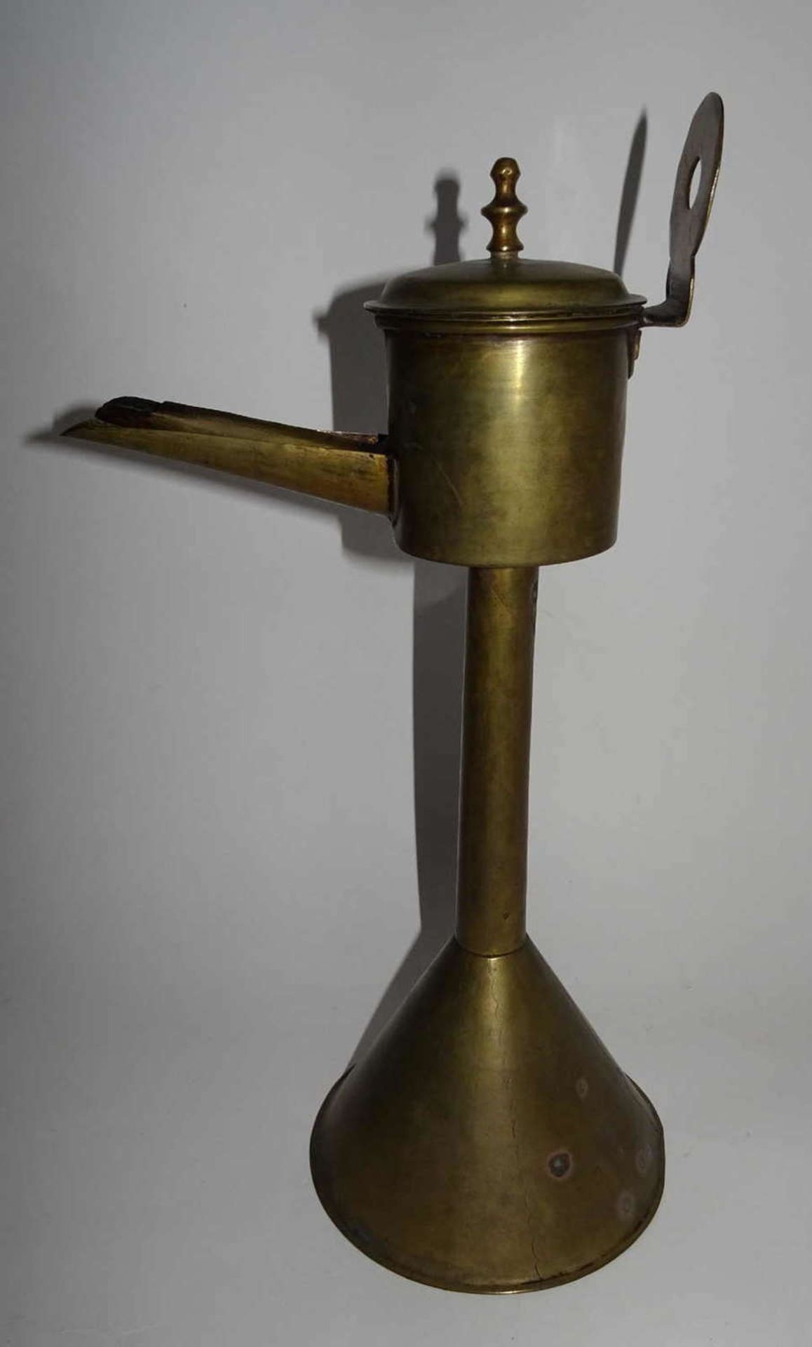 1 failed lamp with oil can and wick. Height about 32cm. Also with wall hangings.