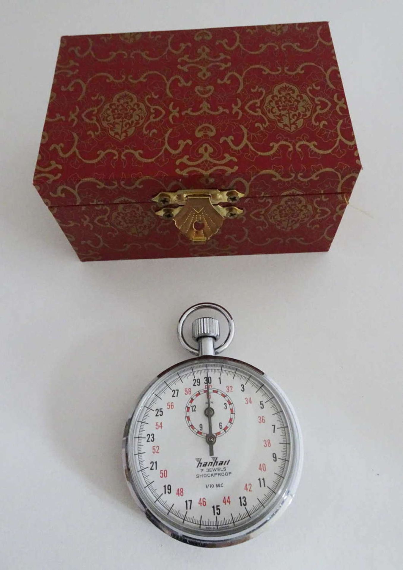 Hanhart stopwatch, crown stopper, mechanical, 7 jewels. In red lacquer wooden box.