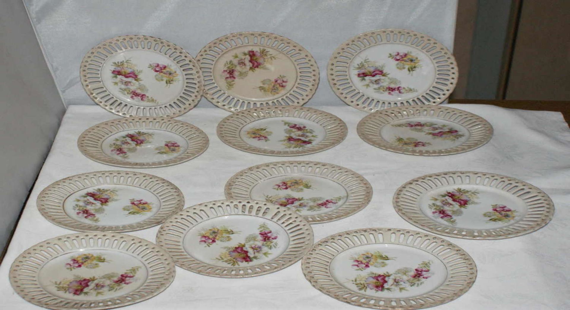 Porcelain, 12 breakthrough plates around 1920 with floral repurposed decoration.