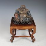 A Chinese lacquer figure of Buddha, late 19th/ early 20th century, marked 'FOOCHOW', on square