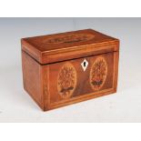 A George III mahogany and marquetry inlaid tea caddy, the hinged cover inlaid with a basket of