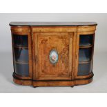 A Victorian walnut, porcelain and gilt metal mounted credenza, the shaped rectangular top above a