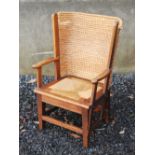 A child's Orkney chair, with drop in woven seat, raised on tapered square supports united by