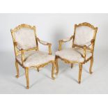 A pair of Louis XV style gilt wood fauteuil, the foliate upholstered back, arms and seats raised