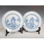 A pair of Chinese porcelain blue and white plates, Qing Dynasty, decorated with pavilions, pine