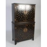 A decorative Indonesian black lacquered butterfly cabinet on stand, the upper section with a pair of