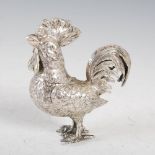 A late 19th/ early 20th century white metal cockerel, with detachable head and hinged wings,