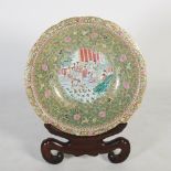 A large modern Chinese porcelain Canton style charger on dark wood stand, 20th century, decorated
