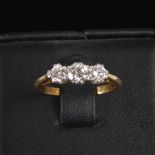 A 20th century three stone diamond ring, centred with a round brilliant cut diamond, calculated to