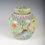 A Chinese porcelain green ground jar and cover, late Qing Dynasty, decorated with a pair of long
