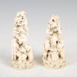 A pair of Chinese ivory figure groups, Qing Dynasty, carved with figures and pine trees, 13cm high