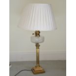 A late 19th century brass Corinthian column oil lamp converted to a table lamp and shade, with clear