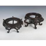 A near pair of Chinese dark wood stands, Qing Dynasty, each with pierced frieze, 24cm diameter x