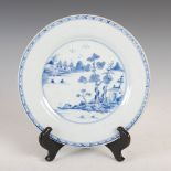 A Chinese porcelain blue and white plate, Qing Dynasty, decorated with pavilions and sampans in a