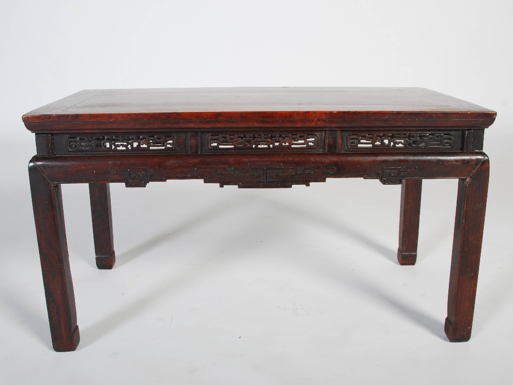 A Chinese dark wood low table, Qing Dynasty, the rectangular panelled top above a pierced and scroll - Image 3 of 5