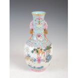 A Chinese porcelain turquoise blue ground famille rose twin handled bottle vase, Qianlong seal