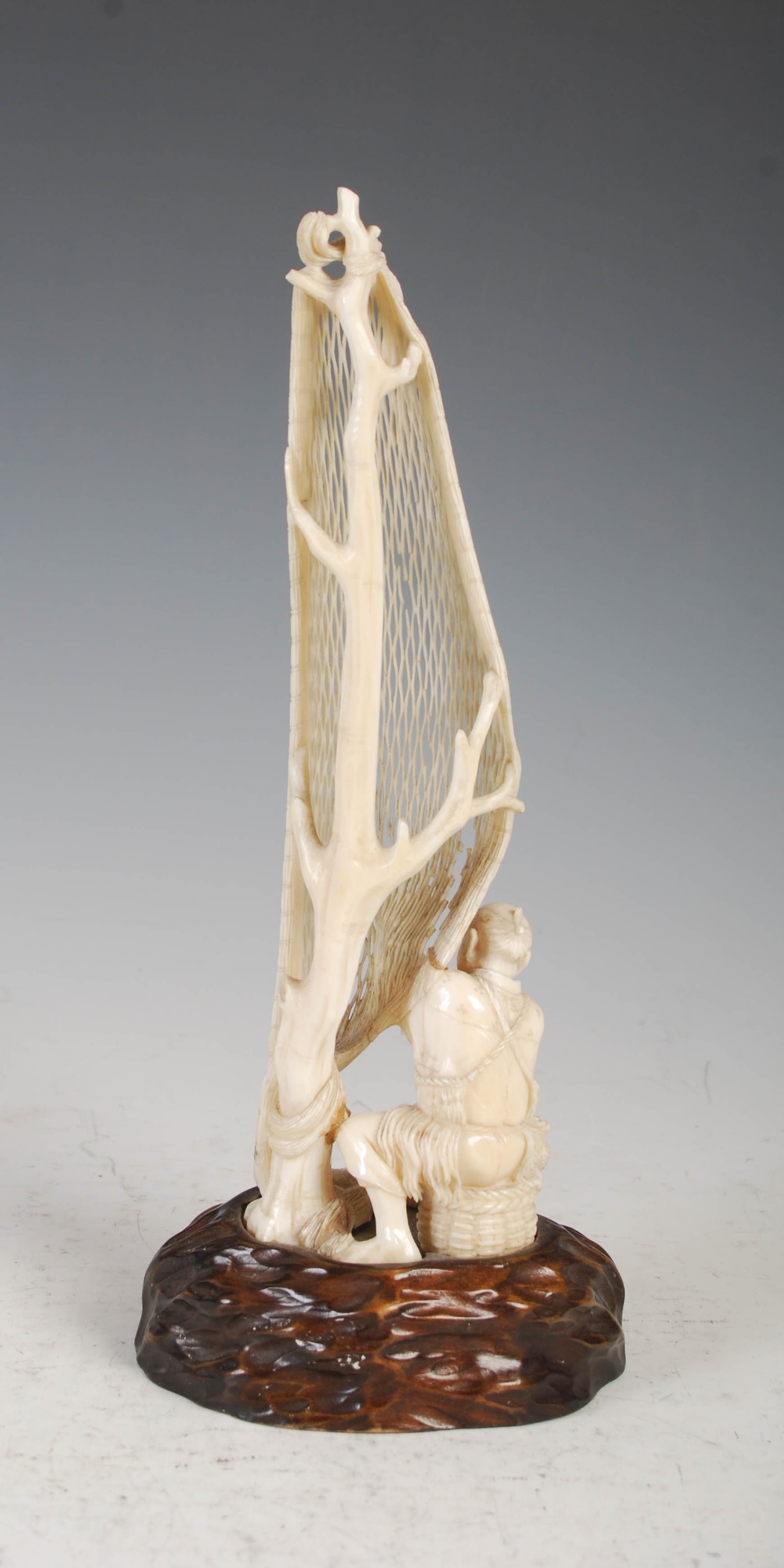 A Japanese ivory okimono of a fisherman tending net, Meiji Period, on carved wood stand, overall - Image 3 of 9