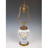 A 19th century Delft pottery jar converted to a table lamp, decorated with flowers, foliage and