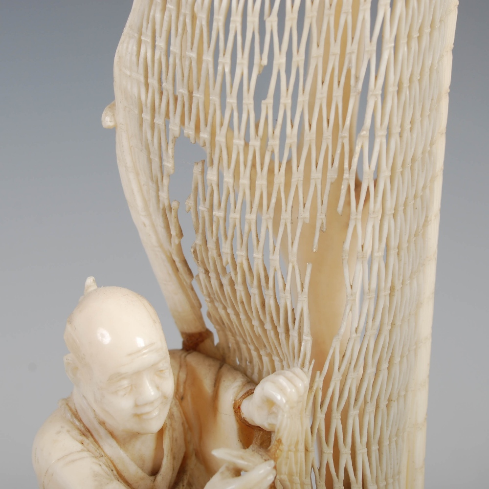 A Japanese ivory okimono of a fisherman tending net, Meiji Period, on carved wood stand, overall - Image 6 of 9