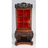 A Chinese dark wood cabinet on console table, Qing Dynasty, the cabinet section with a pierced and