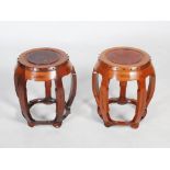 A pair of Chinese dark wood and burr wood drum shaped stools, late 19th/early 20th century, the