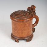 A Scandinavian burr wood/ lignum vitae peg tankard, possibly 17th/ 18th century, with scroll