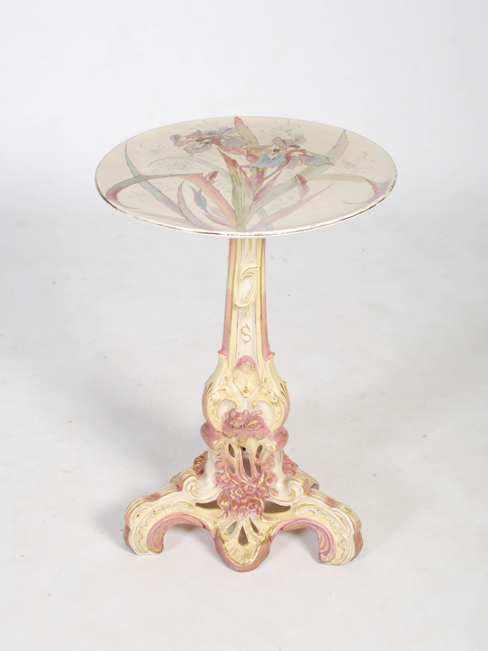 A late 19th century pottery occasional table, the circular top decorated with iris, raised on a