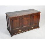 A late 18th/19th century stained oak coffer, the hinged planked top opening to a fitted interior