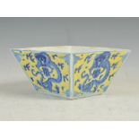 A Chinese porcelain yellow ground blue and white tapered square dragon bowl, Qing Dynasty, the