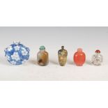 A group of five Chinese snuff bottles, Qing Dynasty, to include; a blue and white porcelain circular