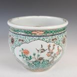A Chinese porcelain famille verte jardiniere, Qing Dynasty, decorated with oval shaped panels