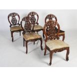 A set of five 19th century Anglo Indian rosewood side chairs, the oval backs carved and pierced with