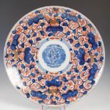 A Japanese Imari charger, Meiji Period, decorated with a central roundel enclosing chrysanthemum,