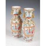 A pair of Chinese porcelain famille rose Canton vases, Qing Dynasty, decorated with rectangular