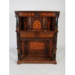 An 18th/19th century oak and marquetry inlaid court cupboard, the rectangular top above a foliate