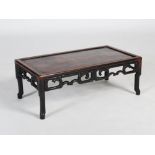 A Chinese dark wood Kang table, Qing Dynasty, the rectangular panelled top above a simulated