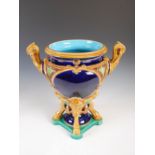 A late 19th century Majolica pottery twin handled jardiniere, raised on four hoof feet and