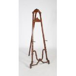 An early 20th century oak easel, with fluted and scroll carved detail, 176cm high.