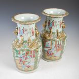 A pair of Chinese porcelain famille rose Canton vases, Qing Dynasty, decorated with panels of