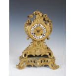 A late 19th century French Rococo style ormolu mantle clock, the circular dial with enamelled