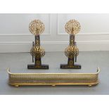 A pair of early 20th century cast iron, steel and brass andirons and a 19th century pierced brass