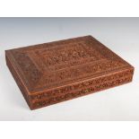 A 19th century Anglo-Indian carved sandalwood box, the hinged rectangular cover carved with a