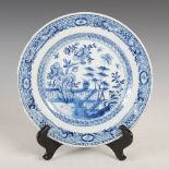A Chinese porcelain blue and white plate, Qing Dynasty, decorated with a garden of peony and